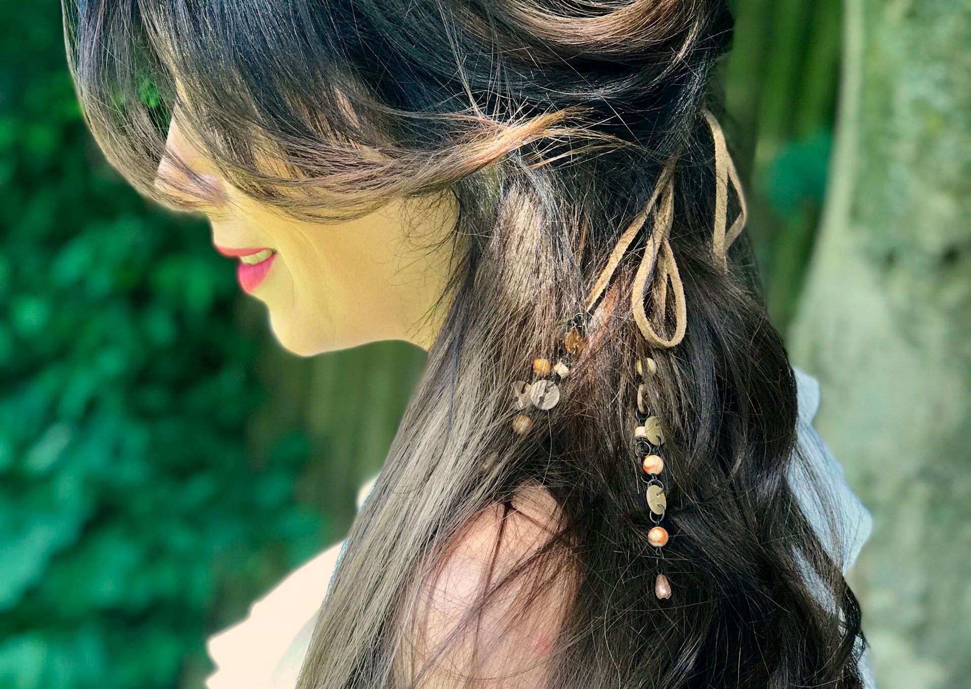 Woman with long brown hair wears Hairdreams Leather Ribbons in her hairstyle