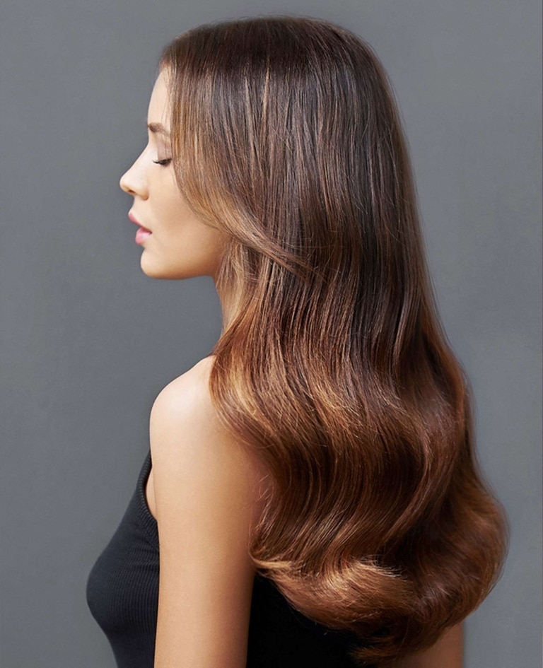 Woman with long hair in trendy balayage look