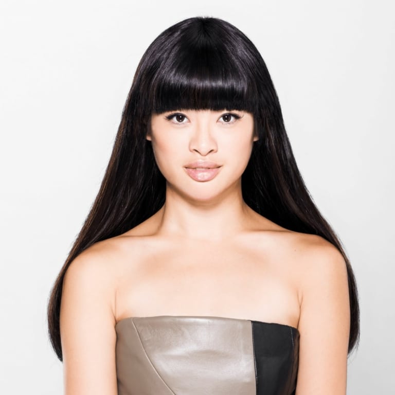 Asian woman with long black hair and forehead fringe
